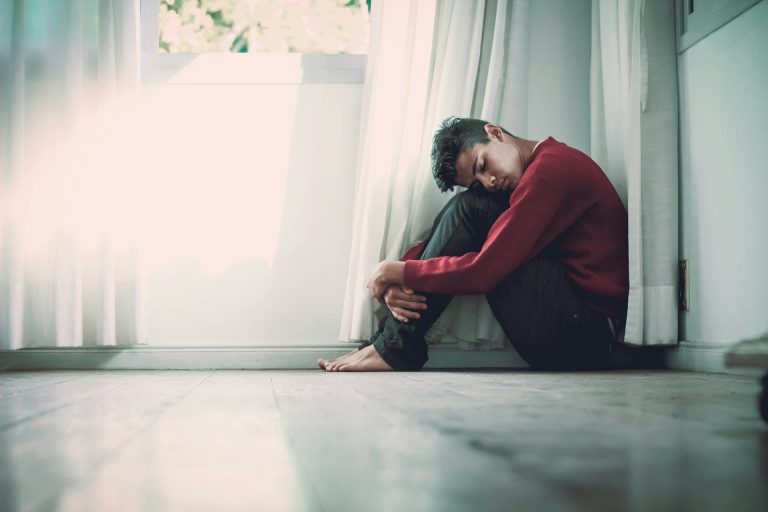 Man leaning against window