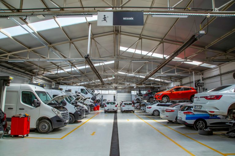 mehmet-talha-onuk-5M-72czGFl4-unsplash A warehouse filled with lots of cars and trucks