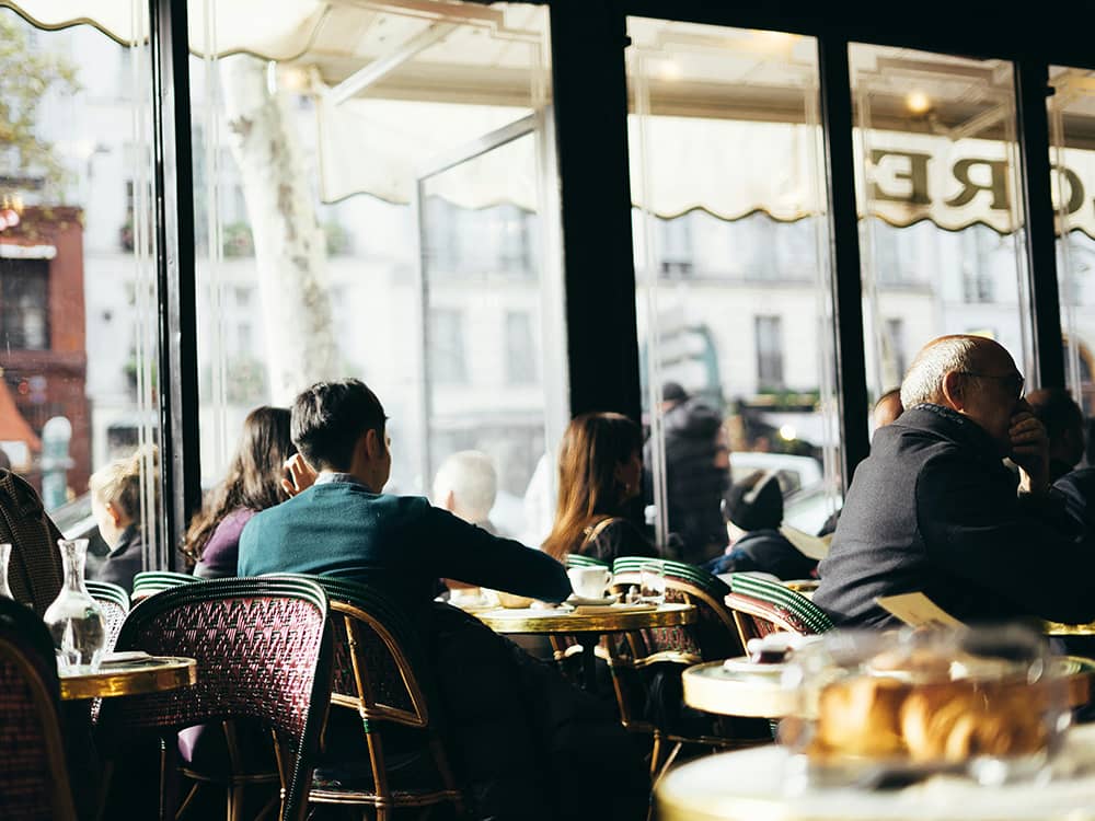 valentin-kremer-4ia_6JMu6Mg-unsplash People eating in a restaurant